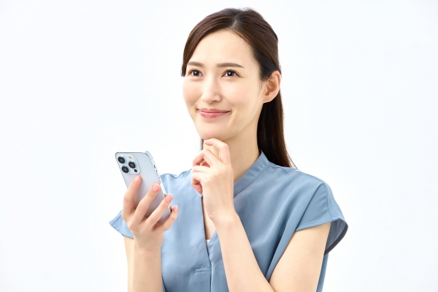 スマホをしながら何かを想像する女性